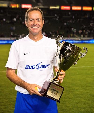 Former USA Team Captain Thomas Dooley poses with the Legends Game trophy