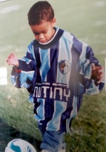 Ariel Lassiter as a young soccer player wearing his dad's soccer jersey.