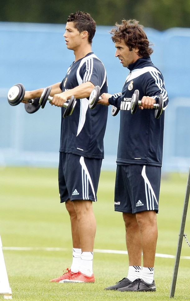 Raul and Ronaldo lift weights during a training session