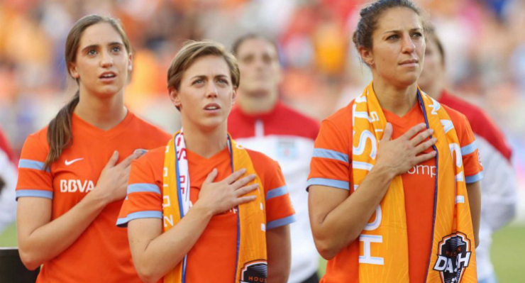 Morgan Brian, Meghan Klingenberg, and Carli Lloyd join their team during the national anthem before the match. Photo Courtesy of Jon Shapley, Houston Chronicle. 