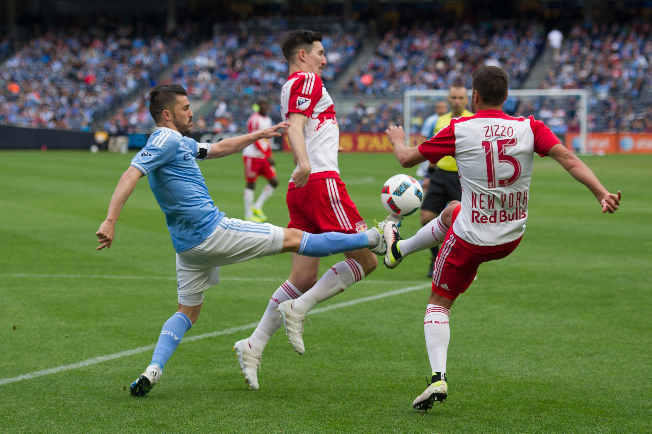 May 21, 2016; New York, NY, USA; New York City FC forward David Villa (7) and New York Red Bulls midfielder Salvatore Zizzo (15) fight for the ball in the second half at Yankee Stadium. New York Red Bulls defeat the New York City FC 7-0.Mandatory Credit: William Hauser-USA TODAY Sports
