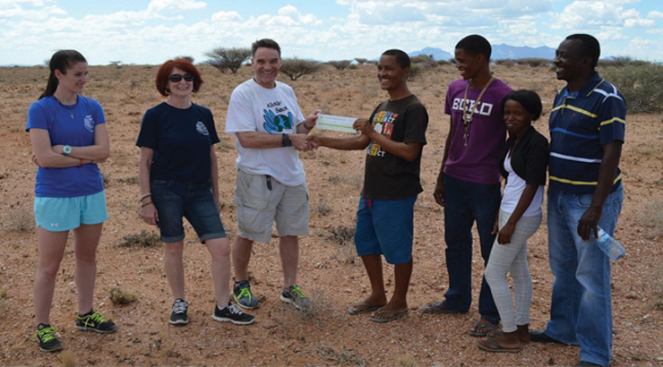 Kieran giving a voucher for 10,000 liters of water to Namibia residents. Daughter Aislinn McIlvenny is on the far left with Kieran’s wife Donna next to him.