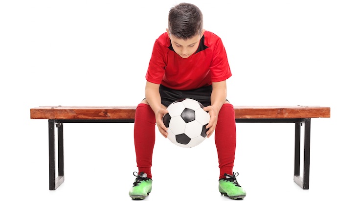 Sad soccer player on bench