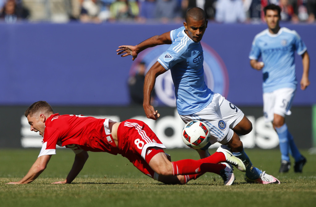 Mar 26, 2016; New York, NY, USA; New England Revolution defender Chris Tierney (8) and New York City FC forward Tony Taylor (99) battle for the ball during first half at Yankee Stadium. Mandatory Credit: Noah K. Murray-USA TODAY Sports